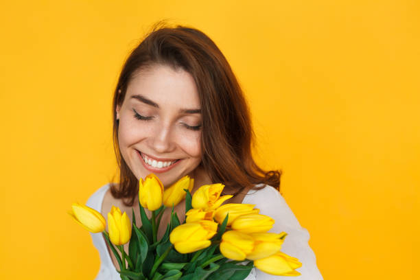 istock Brunette woman holding flowers smiling 820551366