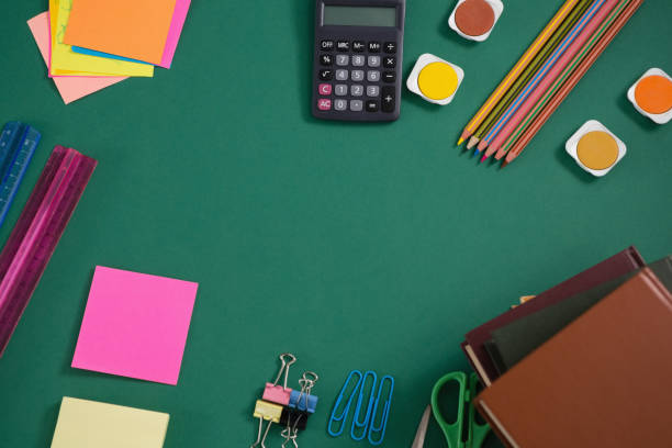 istock Various school supplies on green background 820552036