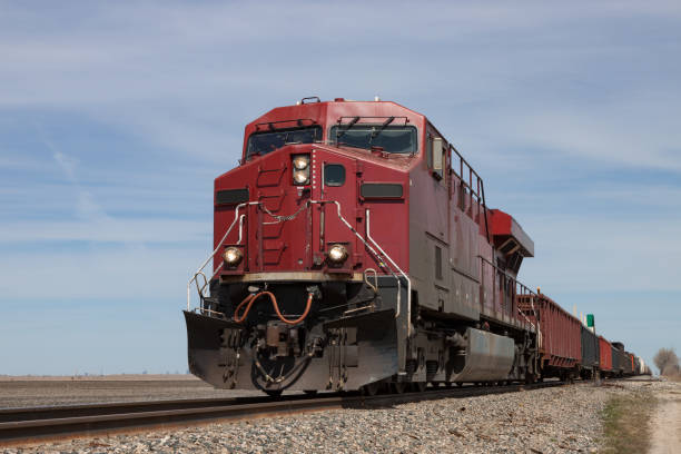 istock Big Red Locomotive Leading Freight Train on Prairie 820552372
