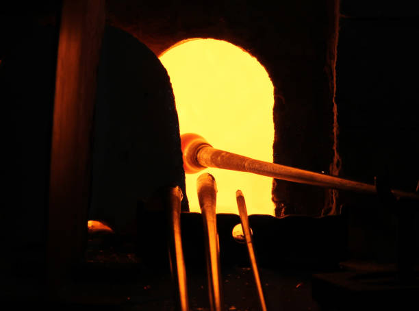 istock Glass Artist in her workshop making glassware 820554558