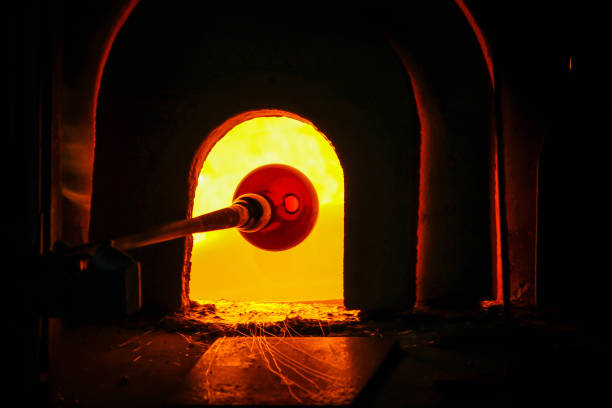 istock Glass Artist in her workshop making glassware 820555504
