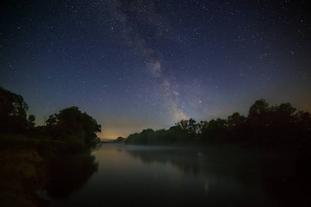 istock Starry night sky with the Milky Way over the river. 820555560