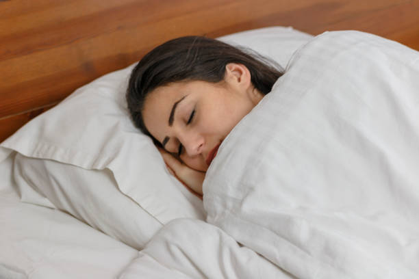 istock Beautiful woman sleeps in bed 820556702