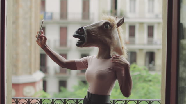 Beautiful black woman take a selfie with horse head