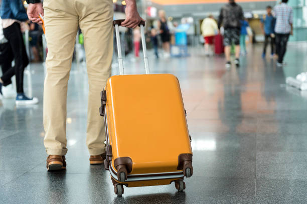 istock Male person holding handle of baggage 820562256
