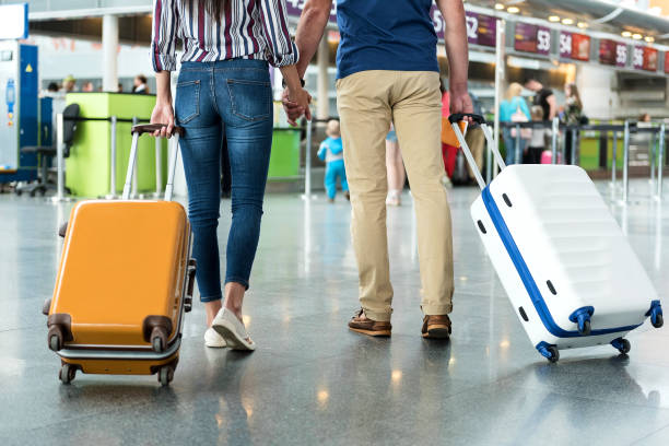 istock Passengers carrying their suitcase on wheels 820562342