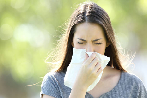 istock Girl sneezing and blowing in a wipe 820566628