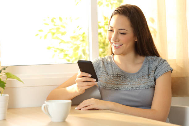 istock Single girl chatting on a mobile phone at home 820568978
