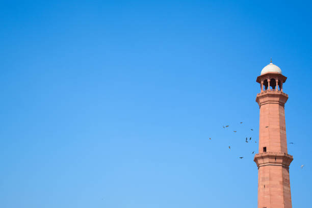 badshahi mosque which is called shahi mosque with a very clear sky and beautiful birds surrounding