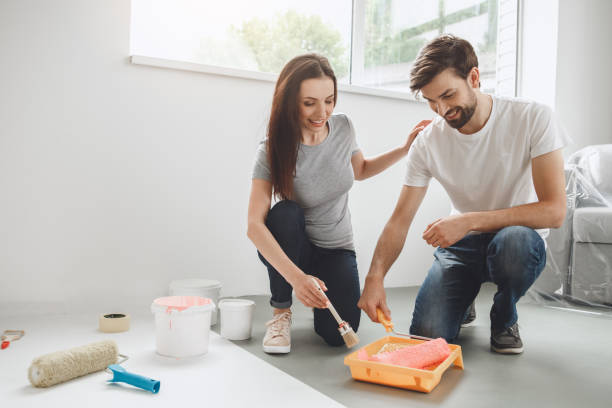 istock Young couple doing apartment repair together themselves 820571002