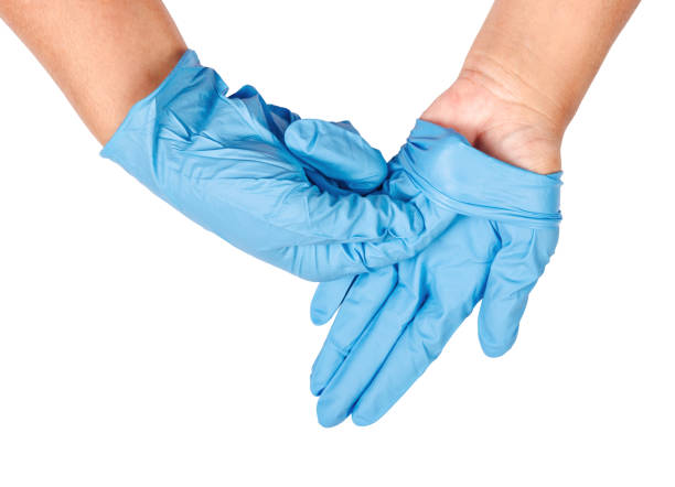 Hand throwing away blue disposable gloves Hand throwing away blue disposable gloves medical, Isolated on white background, Save clipping path. Infection control concept. neoprene photos stock pictures, royalty-free photos & images