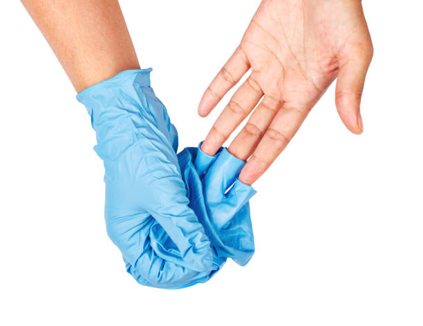 hand throwing away blue disposable gloves - plucking an instrument imagens e fotografias de stock