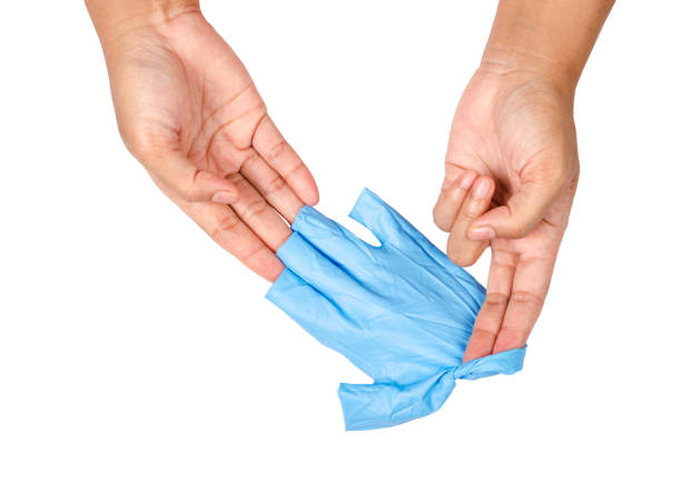hand throwing away blue disposable gloves - plucking an instrument imagens e fotografias de stock