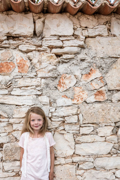 istock Pretty girl in front of a stone wall 820576774