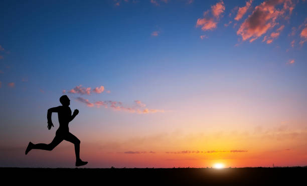istock Running man silhouette in sunset time. Sport and active life concept 820576792