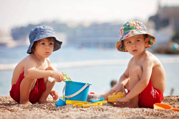 istock Two cute kids, playing in the sand on the beach 820576966