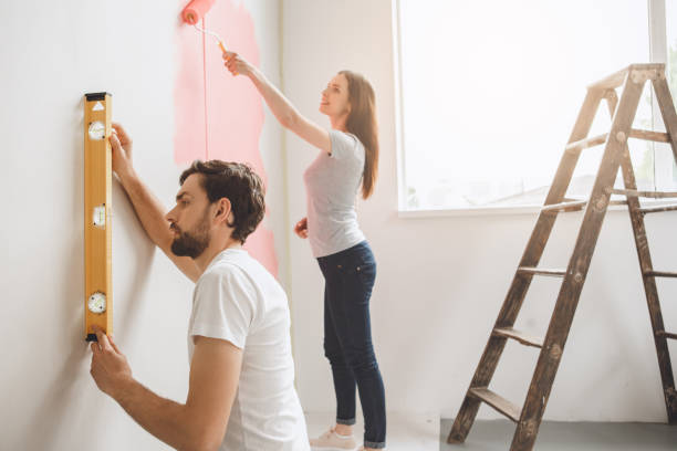 istock Young couple doing apartment repair together themselves 820577156