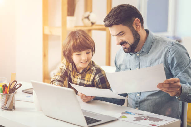 istock Pleasant caring father helping his son with school homework 820577300