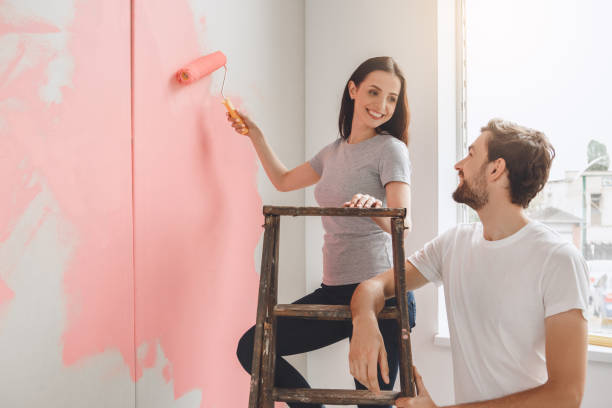istock Young couple doing apartment repair together themselves 820577426