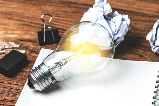 istock great idea concept with crumpled office paper and light bulb standing on table 820580678