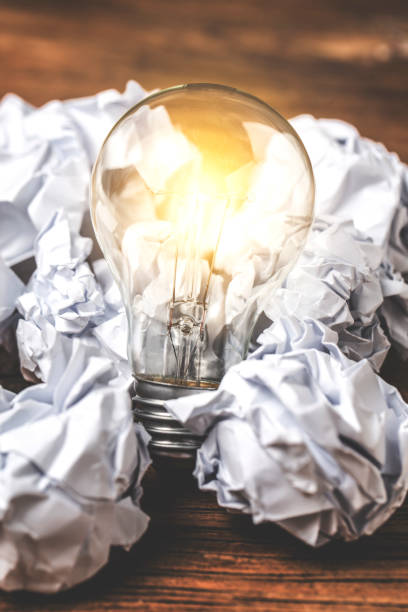istock great idea concept with crumpled office paper and light bulb standing on table 820582994