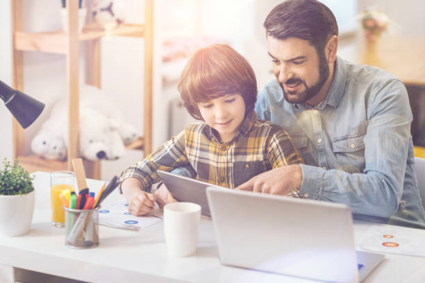 Happy delighted man pointing at the tablet screen
