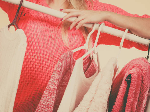 istock Woman hands picking clothes from hangers 820584516