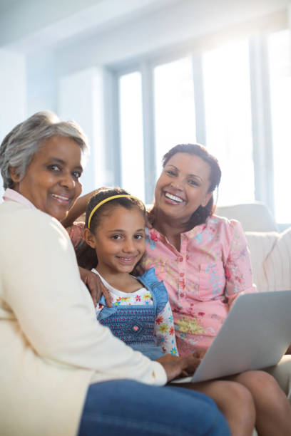 istock Happy family using laptop in living room 820589042