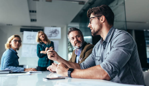 istock Team of professionals discussing over new business project 820609122