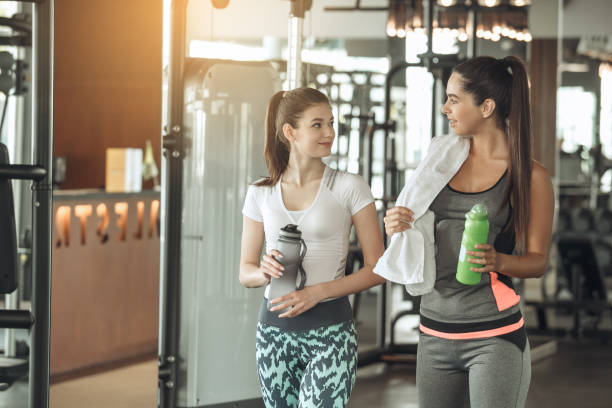 istock Young women exercise together in the gym 820615224