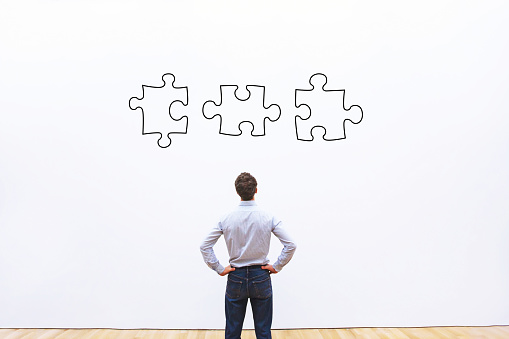 business solution concept, businessman looking at the pieces of puzzle