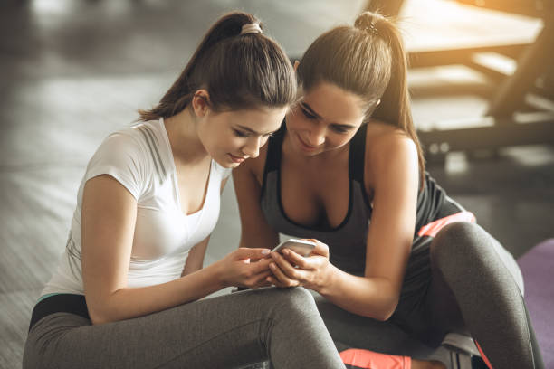 istock Young women exercise together in the gym 820627638