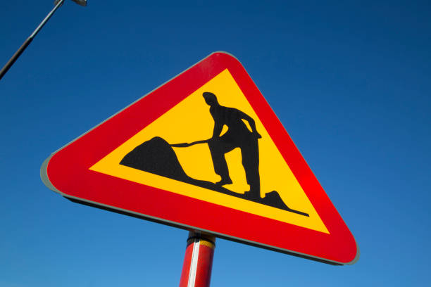 Sign Roadworks and sign Speed limit close-up on a city street on a sunny spring day
