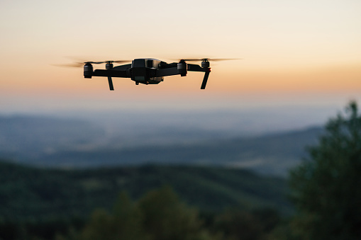 Flying drone at dusk