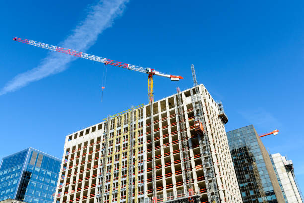 istock Concrete building under construction with a tower crane at the top 820634750