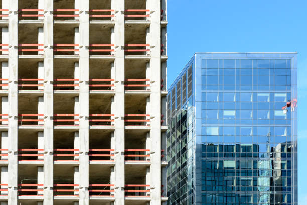 istock Concrete building under construction next to a glass building 820643196