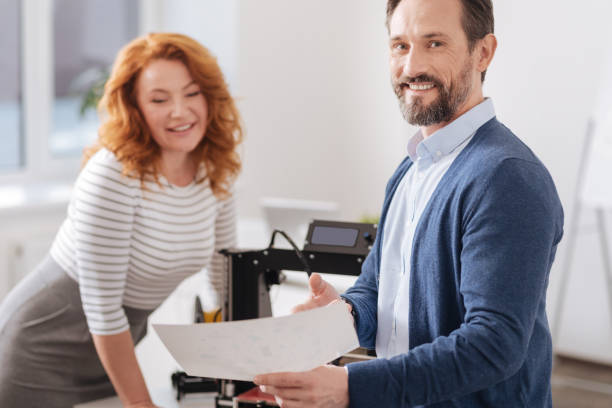 istock Handsome cheerful man holding a drawing 820647442