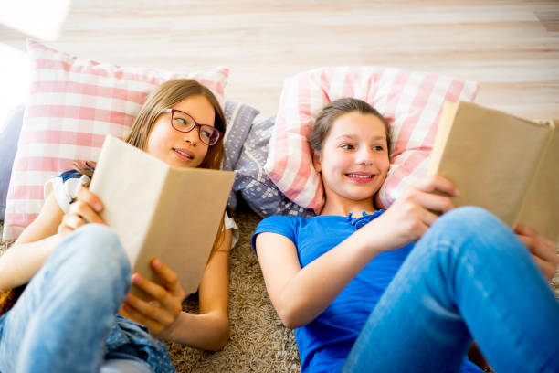 istock Two girls reading books 820647450