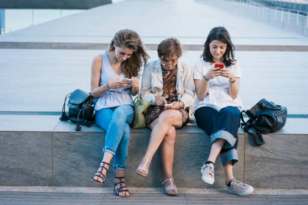 istock Mother and daughters surfing the net with smartphone 820660010