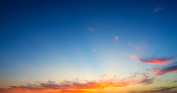 istock orange clouds and blue sky at dusk 820660576
