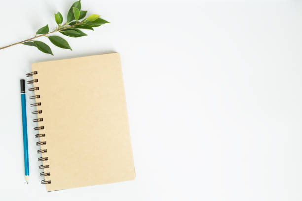 istock Office desk with notebook top view on white background,flat lay image of workplace concept 820672004