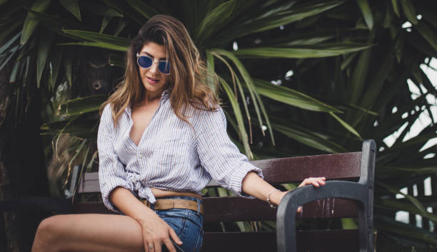 istock Beautiful girl sittin on a bench 820682710