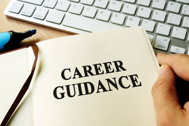 istock Hands holding book with title career guidance. 820699000