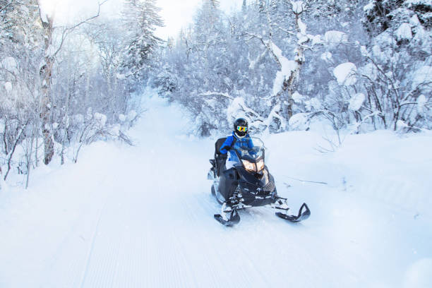 istock Woman driving snowmobile 820711592