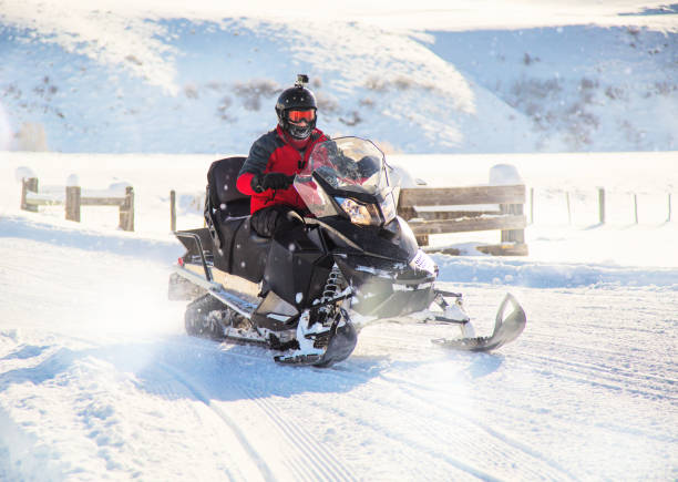 istock Teen driving snowmobile 820712252