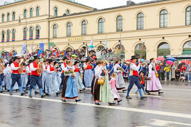 Munich, Germany, September 18, 2016: Visitors watching many German people wearing traditional costumes marching in  Oktoberfest 2016's parade