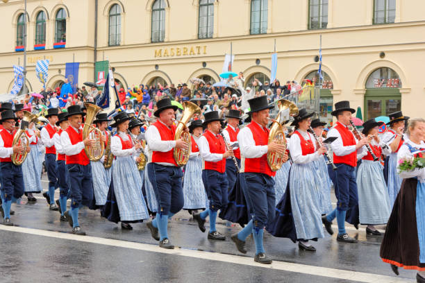 Munich, Germany, September 18, 2016: Visitors watching many German people wearing traditional costumes marching in  Oktoberfest 2016's parade