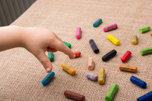istock Used  color crayons and a toddlers hand 820714732