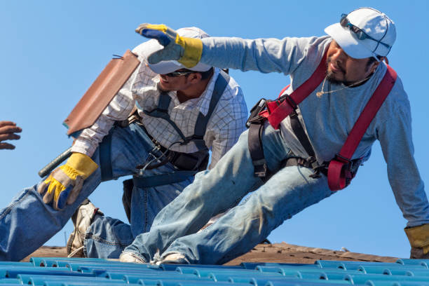 istock Hispanic Roofer Tossing Old Piece of Tile to Another During a Reroof 820719650