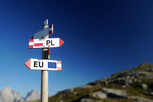Poland and European Union flag in two directions on road sign. Diplomatic crisis Poland and European Union flag in two directions on road sign. Diplomatic crisis law european community european union flag global communications stock pictures, royalty-free photos & images
